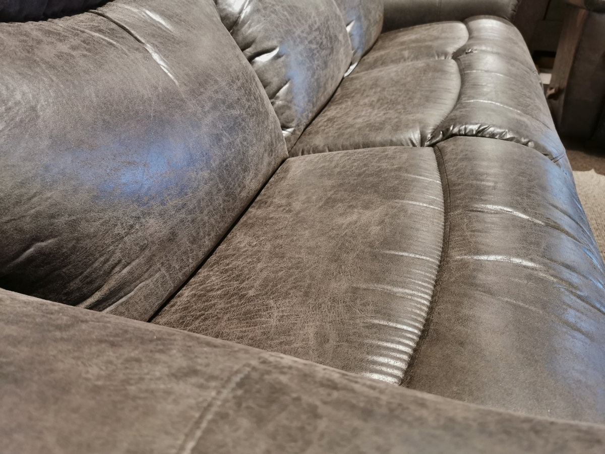 Close-up of the 521 James Sofa by La-Z-Boy, highlighting its gray leather texture, detailed stitching, and plush cushions in a living room setting.