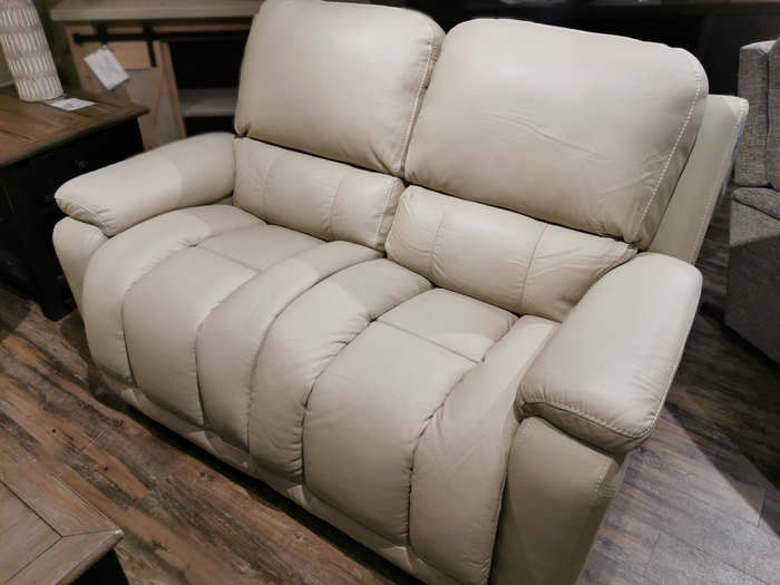 The La-z-boy 530 Greyson Reclining Loveseat in beige leather, equipped with a power recline feature, offers padded seats and armrests, making it ideal for placement on a wooden floor.