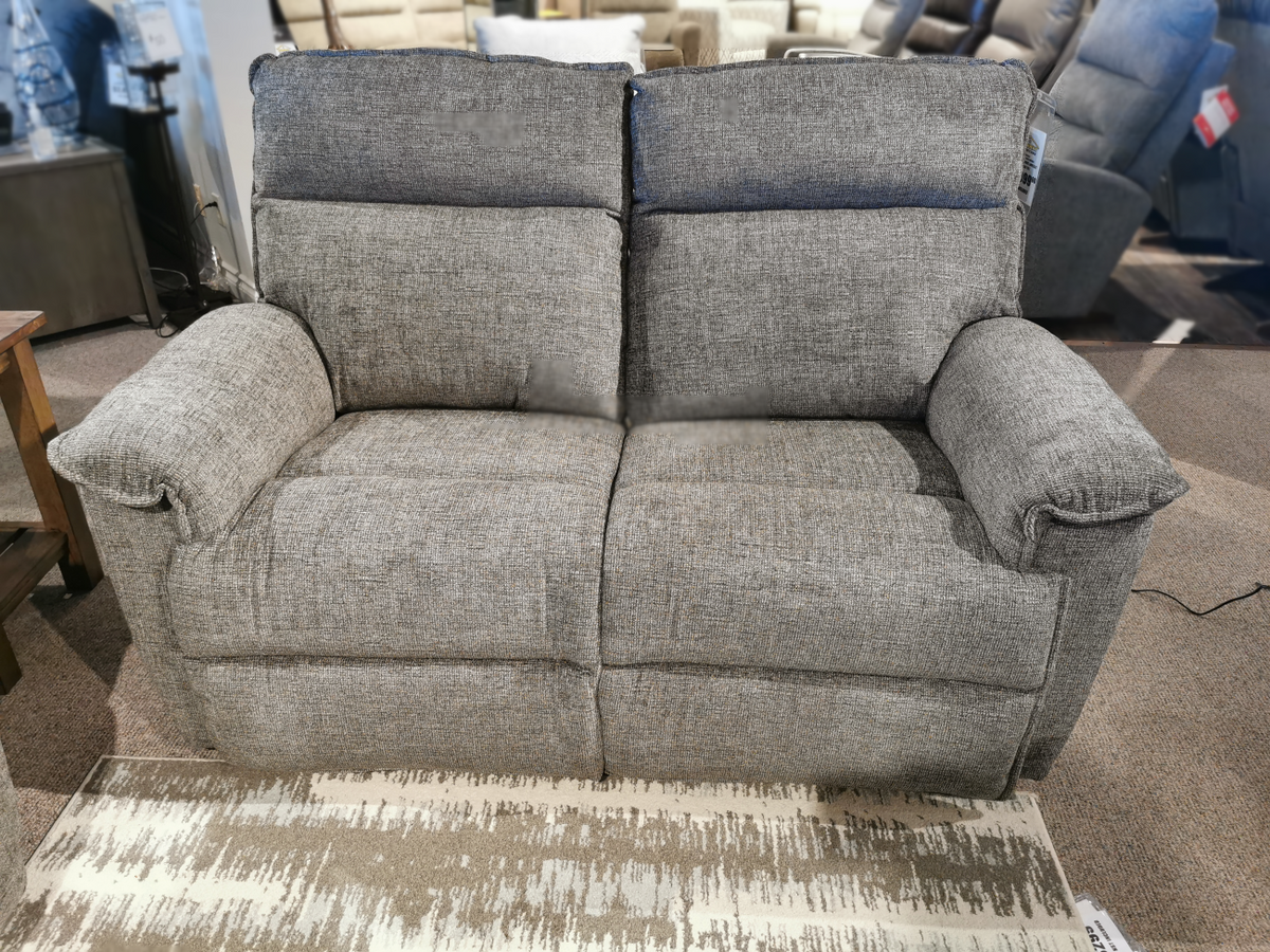 In a showroom setting, the 706 Jay Power Loveseat with headrest by La-Z-Boy offers personalized reclining comfort, elegantly displayed on a beige patterned rug.