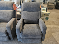 A La-z-boy 747 Finley Wall-a-way Recliner, featuring a contemporary style in gray fabric, is showcased in a furniture store with price tags attached.