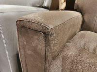 Close-up of the corner of a brown leather couch cushion showcasing textured upholstery and visible stitching details, reminiscent of the plush bucket seat design found in the 757 Apollo Rocker Recliner by La-Z-Boy for modern comfort.