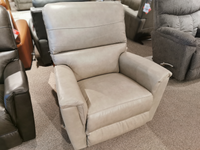 The La-z-boy 769 Ava Rocker Recliner is showcased on a carpeted showroom floor among other versatile chairs.