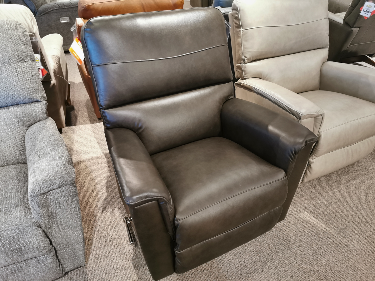 La-z-boy's 769 Ava Rocker Recliner, crafted from brown leather, is showcased alongside other versatile chairs in a showroom setting.