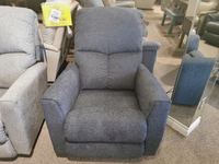 The 780 Hawthorn Power Rocker Recliner by La-z-boy, a gray fabric recliner chair equipped with lumbar support and comfort styling, is displayed with a price tag in the furniture showroom.