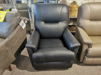 A dark gray La-Z-Boy 783 Aries Rocker Recliner is on display in a furniture store, surrounded by similar reclining rockers, exemplifying comfort and durability.