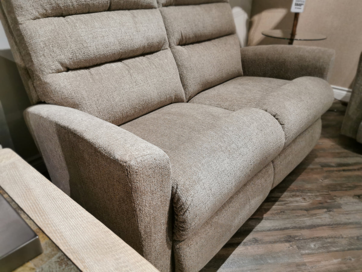 La-z-boy's 786 Liam Reclining Loveseat features plush cushions and armrests, offering comfort and style in a showroom.