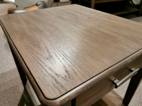 Close-up of the T5695-10 Corden Chairside End Table by Magnussen, showcasing a smooth hickory veneer surface and a metal handle, positioned on a carpeted floor.