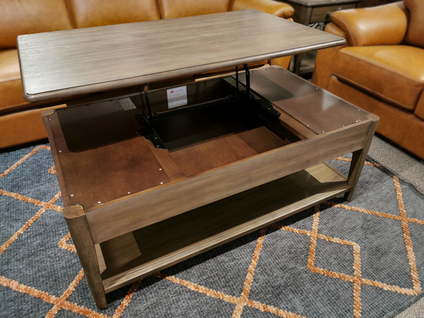 Introducing the T5695-50 Corden Lift Top Coffee Table by Magnussen. This exquisite wooden table is a part of the Corden Collection and showcases a lift-top mechanism that unveils convenient storage space beneath. Expertly crafted with hickory veneer, it complements any patterned rug beautifully and is accentuated by satin nickel hardware for an elegant touch.