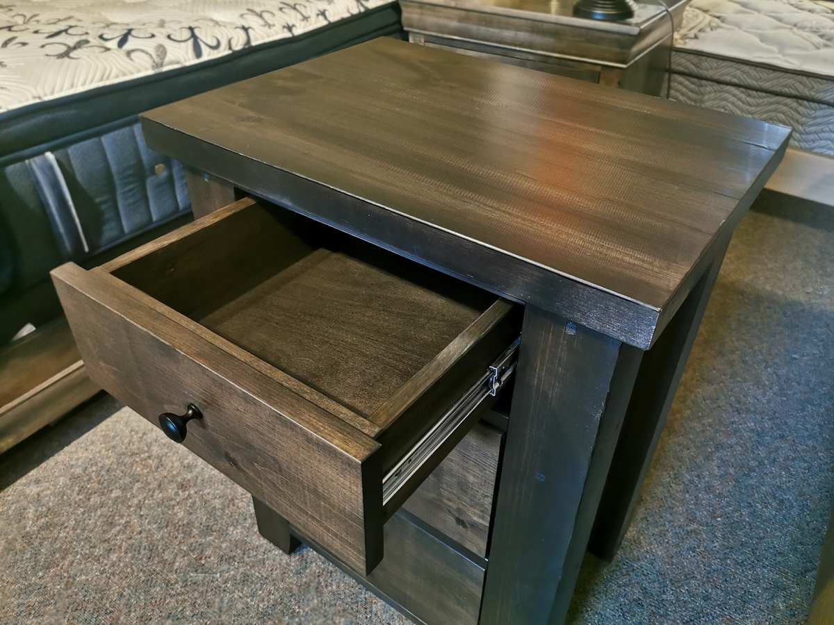 A Munros 3 Drawer Pine Nightstand pairs well with the patterned mattress in this modern bedroom.