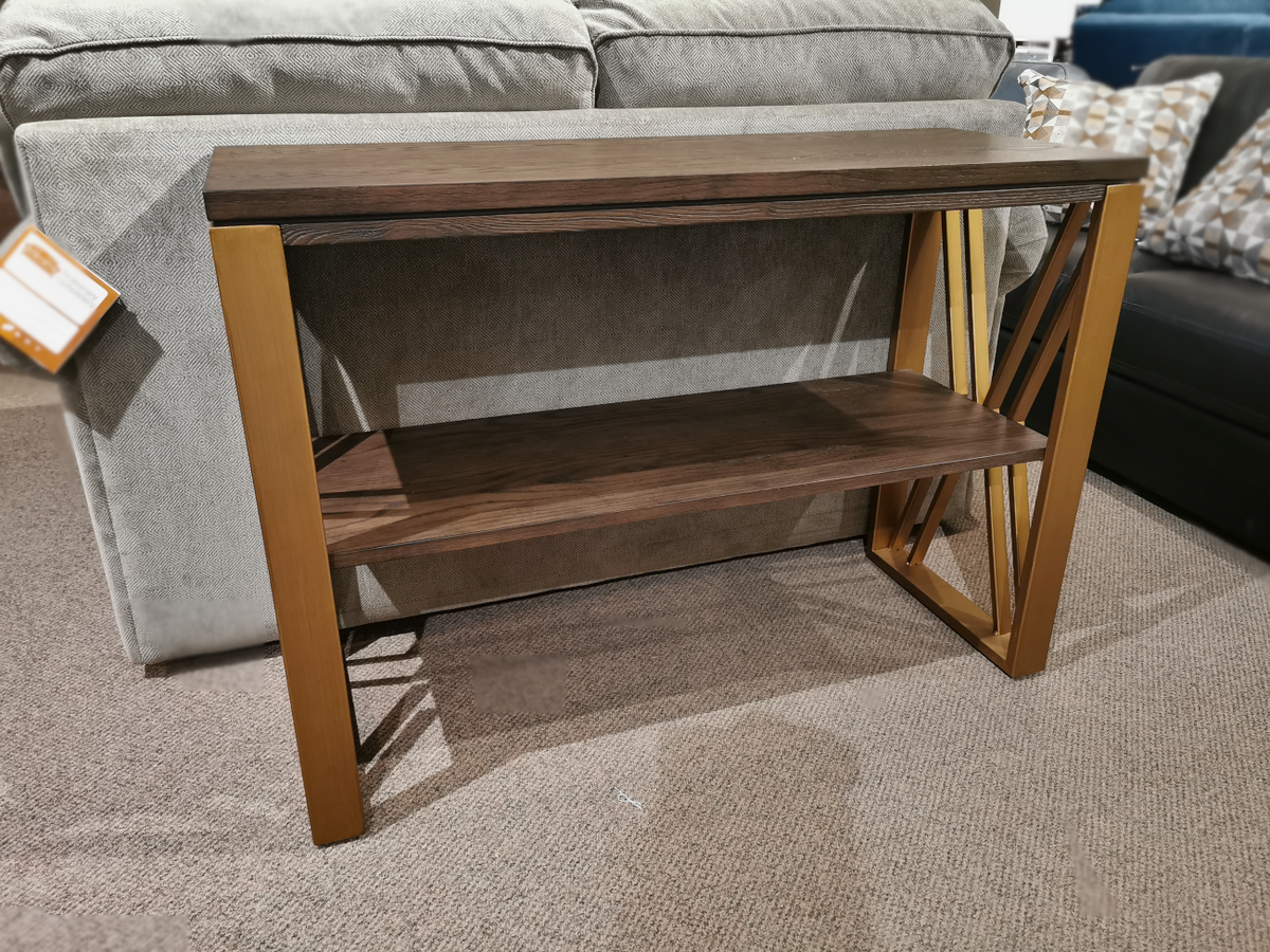 The Westchester 1321 Sofa Table by Null Furniture features an ash veneer top and brass finish legs on a carpeted floor.