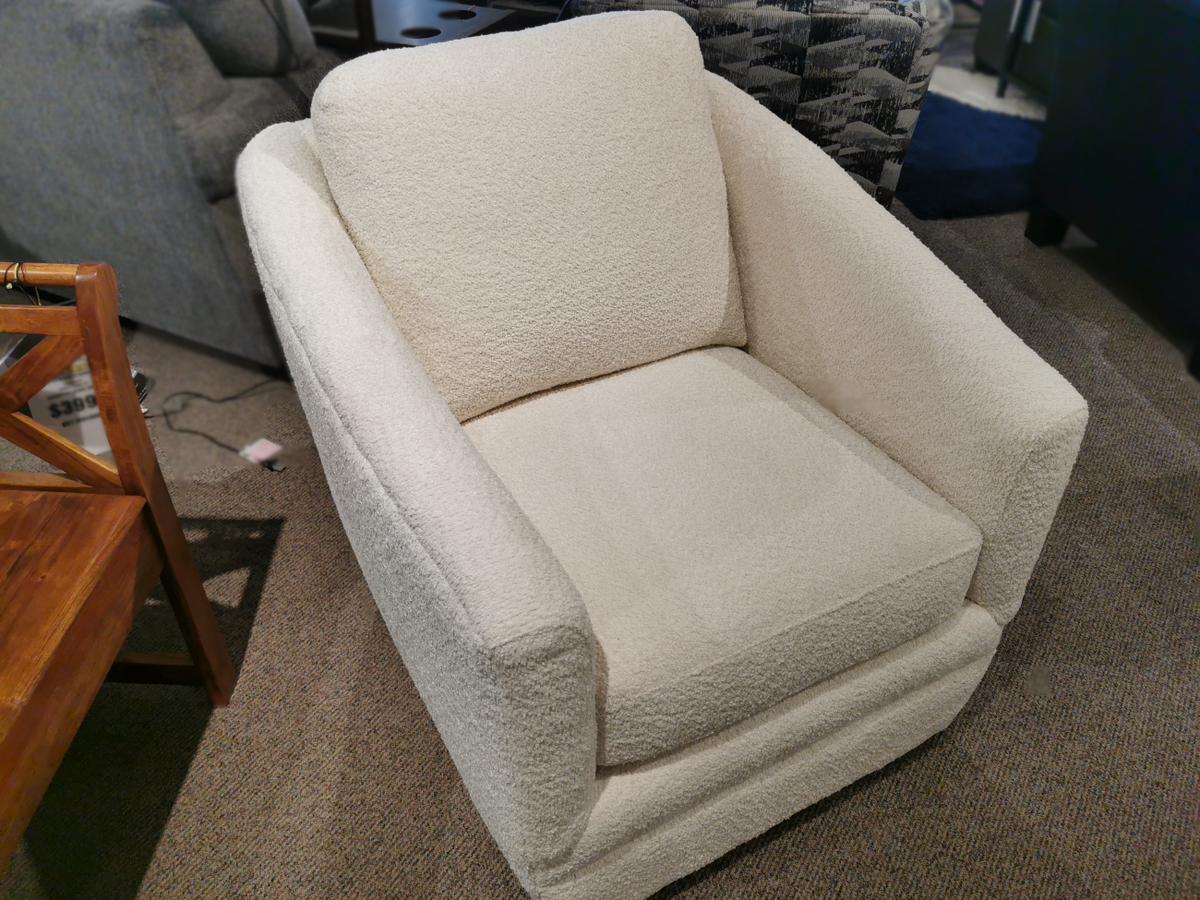 In the showroom, a 312 Swivel Chair by Trendline showcases its white texture as it sits elegantly on the carpet. With dimensions of LDH 32" x 36" x 36", this chair offers a perfect blend of style and comfort.