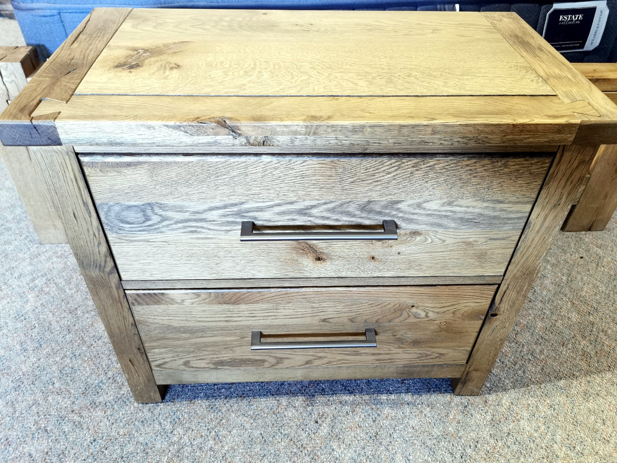 Vaughan Bassett 752 Dovetail 2-Drawer nightstand on carpeted floor with metal handles and American White Oak finish.