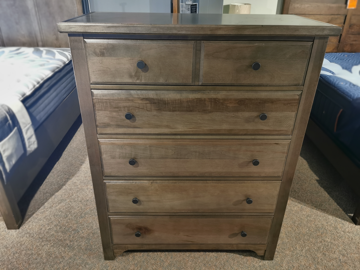 Vaughan Bassett's 801 Cool Farmhouse Chest features cherry veneers, five drawers, and custom pewter pulls on a carpeted floor.