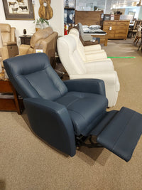 The furniture store showroom features the stunning 42210 Banff II Power Swivel Glider by Palliser, available in various colors, offering ultimate comfort with a touch of Scandinavian design.