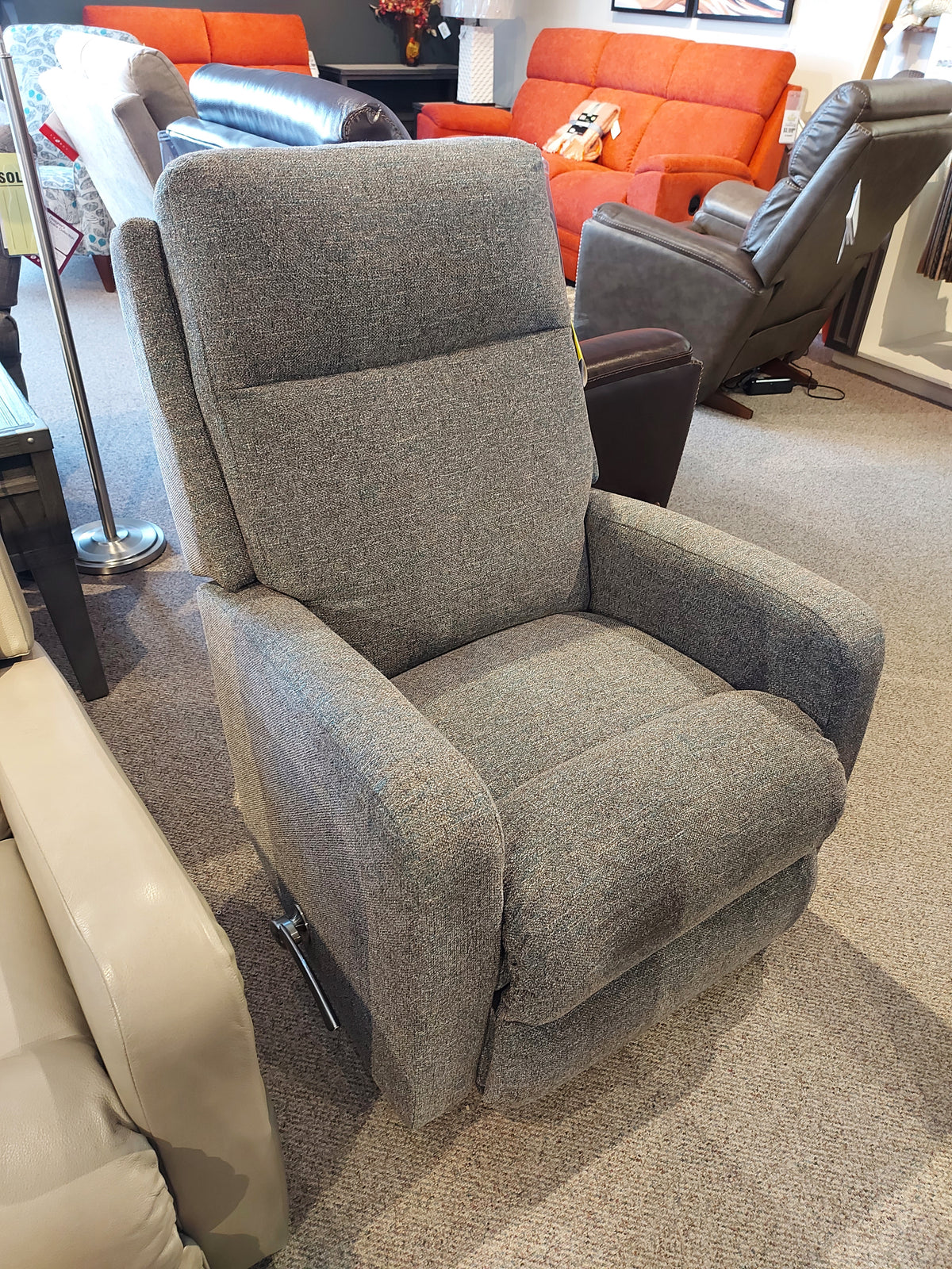 The La-Z-Boy 747 Finley Wall-a-Way Recliner with a contemporary style graces the furniture showroom, with other seating options visible in the background.