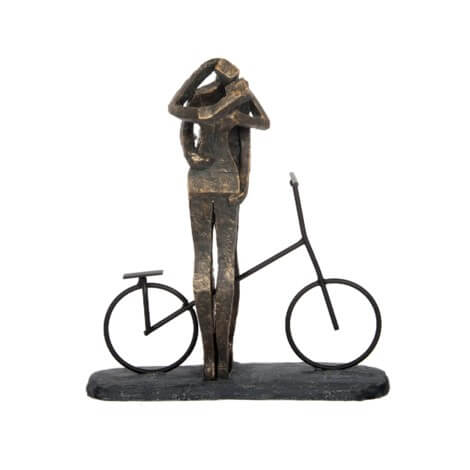 Bronze sculpture titled "Kissing Couple" by Canfloyd, depicting a person standing beside a bicycle with their hand on their head, set on a rectangular base.