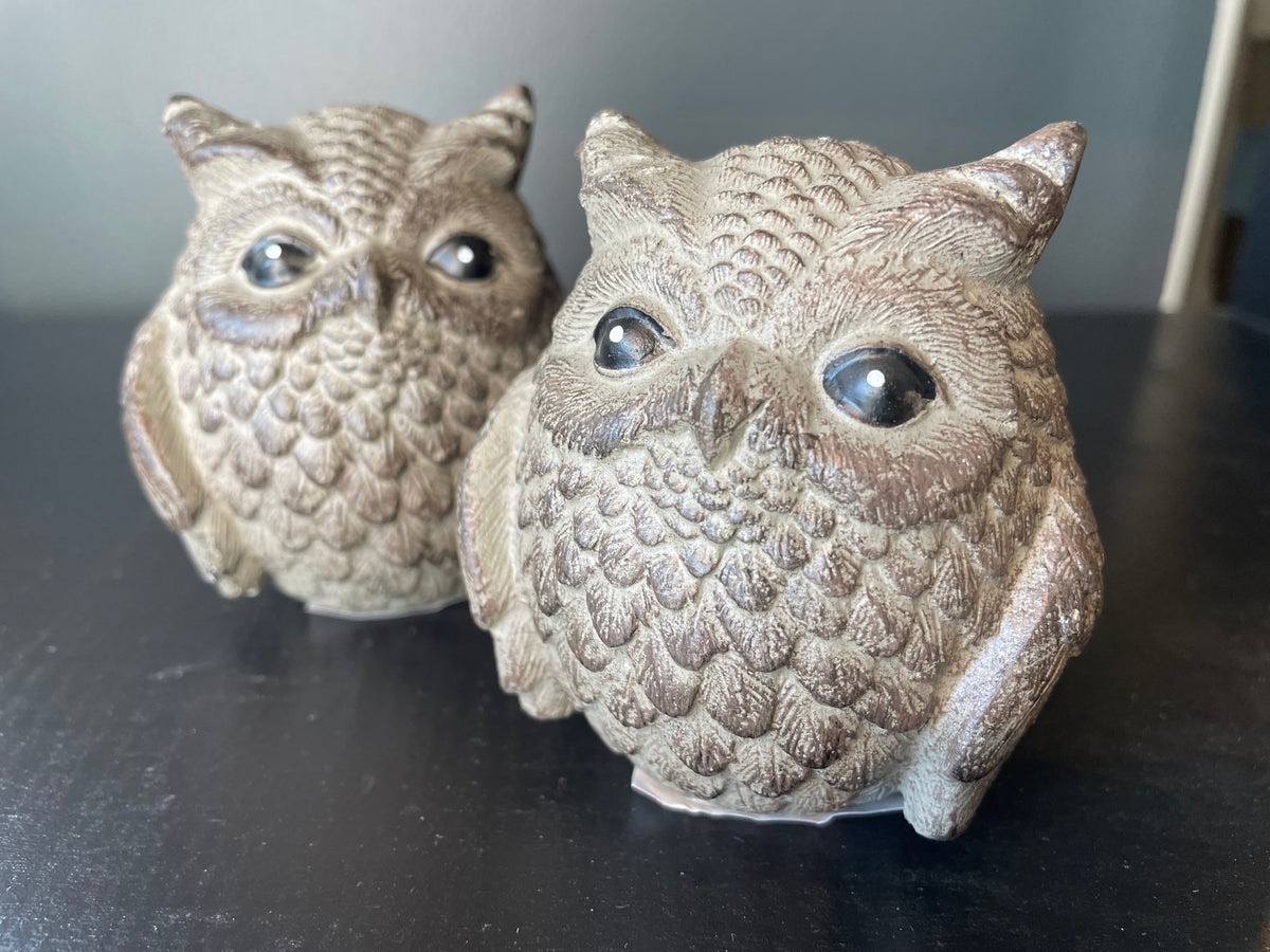 Giftcraft's Cement Owl Figures feature textured details with shiny eyes, set against a surface with black accents.