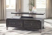 Ashley Tadoe Lift-Top Coffee Table in rustic-industrial style, dark wood finish with 2 drawers, and a plant-topped shelf.