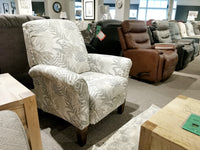 Showroom featuring a diverse array of reclining chairs and armchairs on display, highlighted by a patterned 424 Fletcher Hi-Leg Recliner in the foreground, proudly manufactured by La-Z-Boy in America.