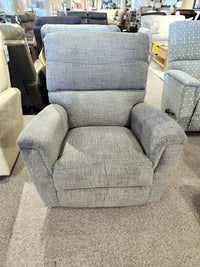 The 769 Ava Rocker Recliner by La-Z-Boy, featuring adjustable support, is displayed on a beige carpet in a furniture showroom.