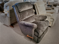 The 519 Astor Rocker Recliner by La-Z-Boy, a sophisticated tall chair in elegant gray, is perfectly showcased among other chairs in the showroom.