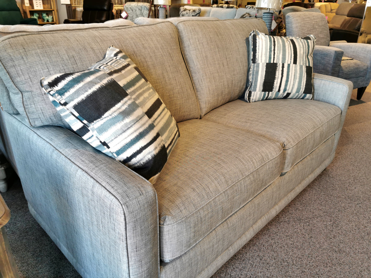 La-Z-Boy's 593 Kennedy Double Sofabed with ComfortCore® cushions, showcased on a carpet amid other showroom furniture.