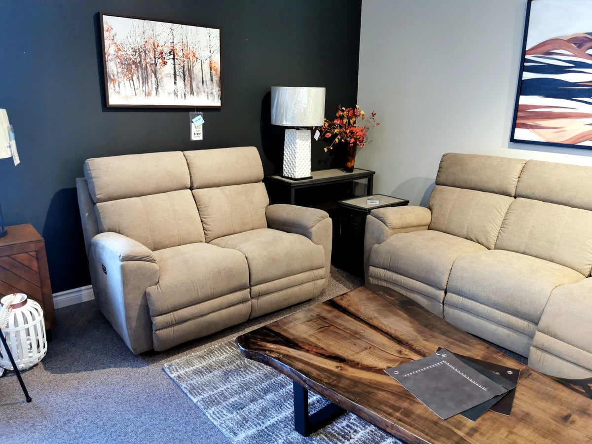 Scene with a La-Z-Boy 754 Talladega Loveseat, wooden coffee table, wall art, lamp, and floral side table arrangement.