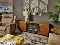 Living room setup with a brown recliner, Bella Mantel by Napoleon featuring Cineview 26, and a patterned rug.