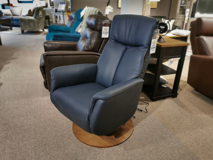 Palliser's 50030 Q30 navy leather swivel recliner offers superior comfort, displayed with chairs and a side table.