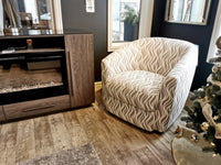 A Palliser 77090M Dorset Swivel Chair is next to a wooden cabinet and a decorated Christmas tree on hardwood flooring.