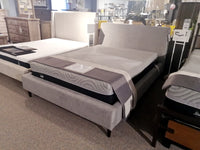 Three 77136 Prairie Queen Upholstered Beds by Palliser feature modern designs and coordinated bedding in a furniture store.