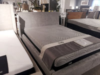 A showroom display features the luxurious Sealy mattress on Palliser's 77136 Prairie Queen Upholstered Bed.