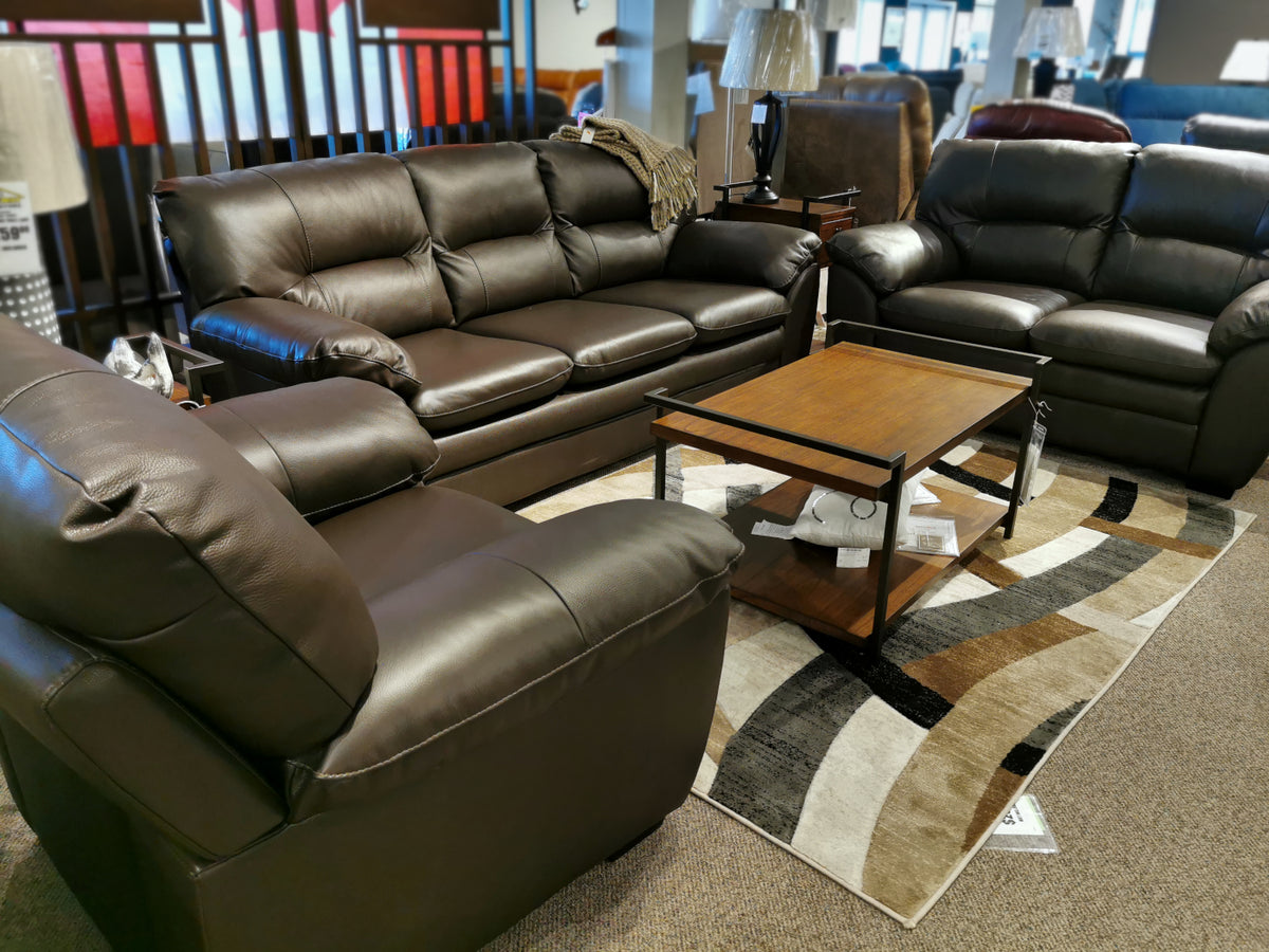 Explore the Amisk collection by Palliser, which includes a 77343 Amisk Loveseat. This living room furniture set features a cozy brown leather sofa, loveseat, and armchair with pillowy-soft backrests for optimal comfort. The set is complemented by a wooden coffee table and a patterned rug to create an inviting atmosphere.