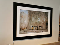 A framed artwork titled "Waiting On A Cab" by Picture Depot is displayed on the wall, showcasing people walking in the rain with umbrellas in a monochromatic color scheme.