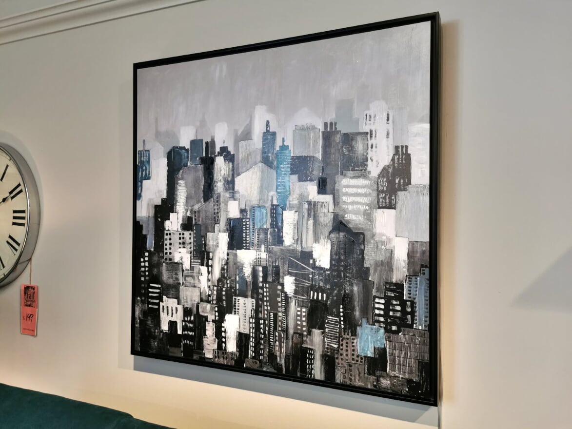 The "Living Uptown" by Picture Depot is a giclee canvas featuring an abstract cityscape with a blend of gray, black, white, and blue tones.