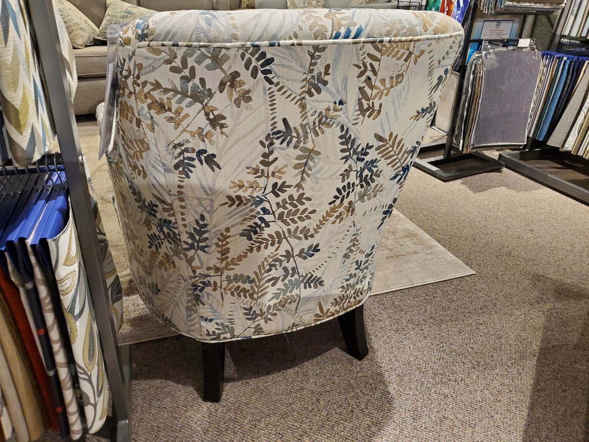 31 Chair - Fendi Sky by Superstyle on carpet beside fabric samples in a Toronto showroom.