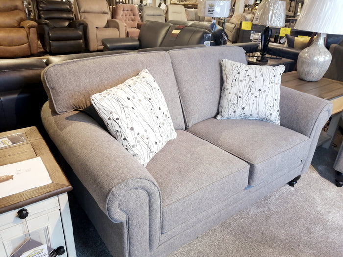 The Superstyle 9613 gray loveseat features premium foam seating and includes two patterned pillows.