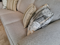 Close-up of the 9613 Loveseat by Superstyle, featuring striped and patterned throw pillows on a gray fabric.