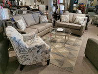 Explore the ideal living room furniture set with two 9670 gray sofas from Superstyle, offering medium-firm comfort. Complementing this setup is a stylish patterned armchair and a modern glass coffee table. Infuse transitional design into your space with decorative pillows that enhance the elegant allure.