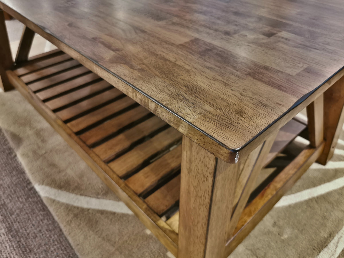 Winners Only NP100C Newport Coffee Table in solid hardwood with a polished top and slatted shelf on a patterned rug.