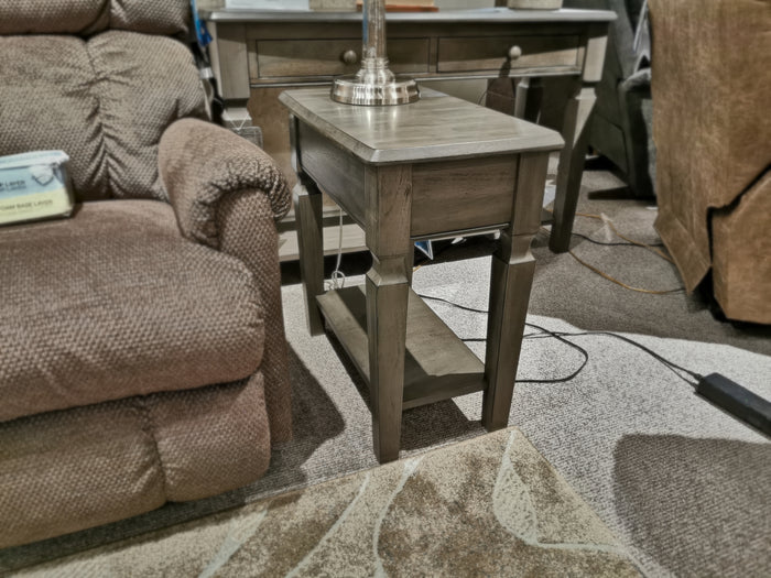 Winners Only's Annapolis 14" Lamp Table with open shelf placed between two brown chairs on a carpeted floor.