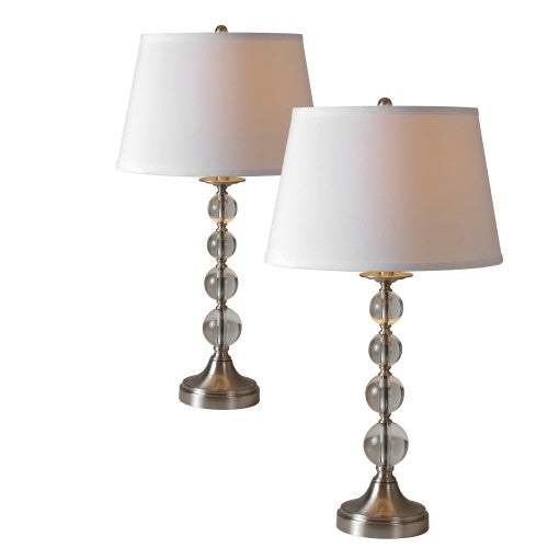 The Venzia Lamp by Renwil is a pair of table lamps showcasing stacked glass spheres with a satin nickel finish, complemented by white fabric shades on crystal and metal bases.